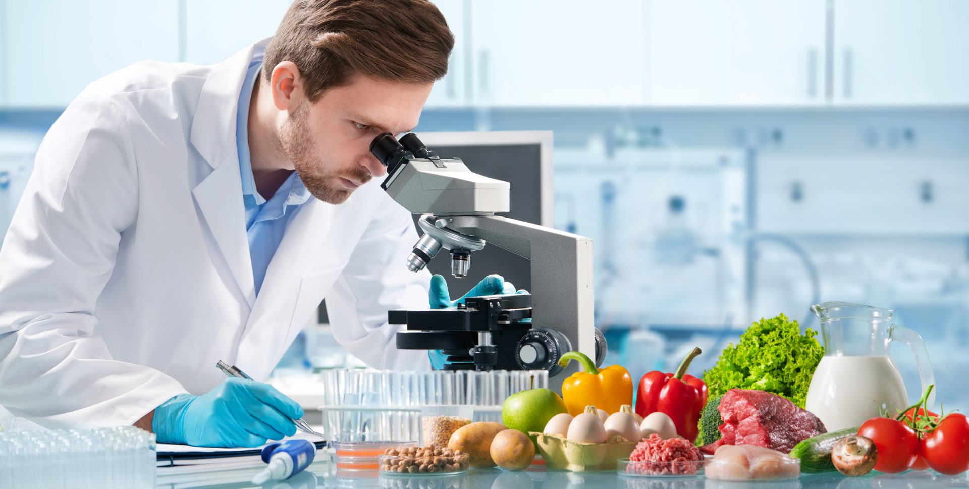 Man looking into a microscope to perform Sampling and testing analysis of food.