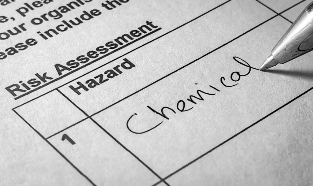 Completing a risk assessment template to identify hazards in the facility and assess for risk.