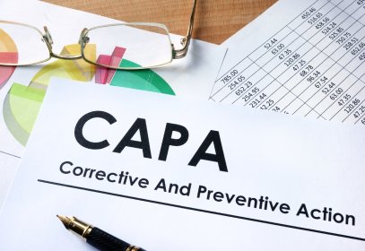 Capa Corrective and Preventive Action paper written on a paper on a desk.