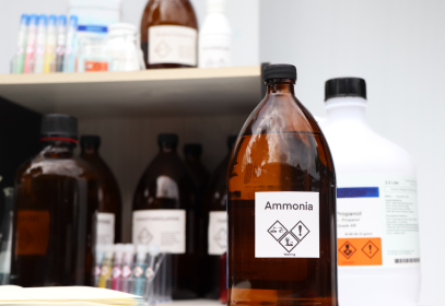 Bottles of industrial chemicals on shelving.