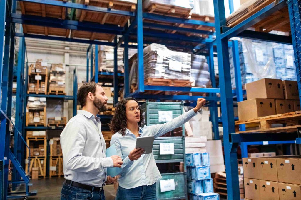 Someone pointing to factory shelf